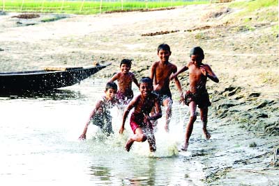SIRAJGANJ: Village children rejoicing in the dried up Jamuna River . This picture was taken from Shohagpur Village of Belkuchi Upazila in Sirajganj yesterday.