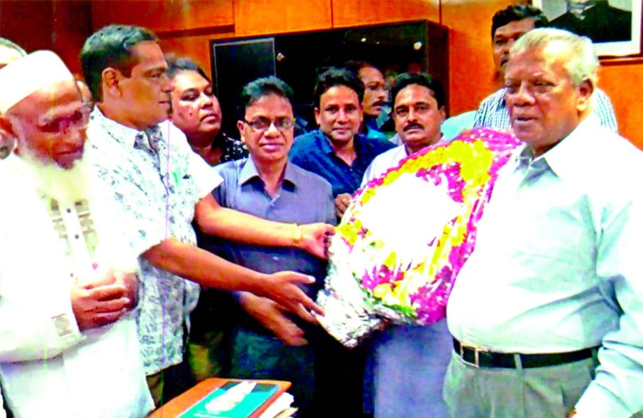 Newly elected committee of Bangladesh Chemical Industries Corporation's (BCIC) Sramic-karmachari Federation receives Minister Amir Hossain Amu with flower bouquet. President of the Federation, M Kamaluddin, General Secretary Sheikh Nurul Hadi, Executive