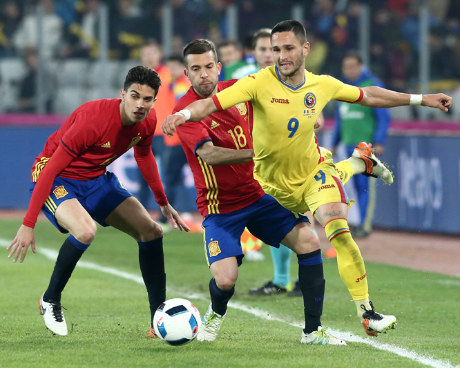 Spain's Jordi Alba (center) challenges Romania's Florin Andone for the ball during a friendly soccer match between Romania and Spain in Cluj, Romania on Sunday.