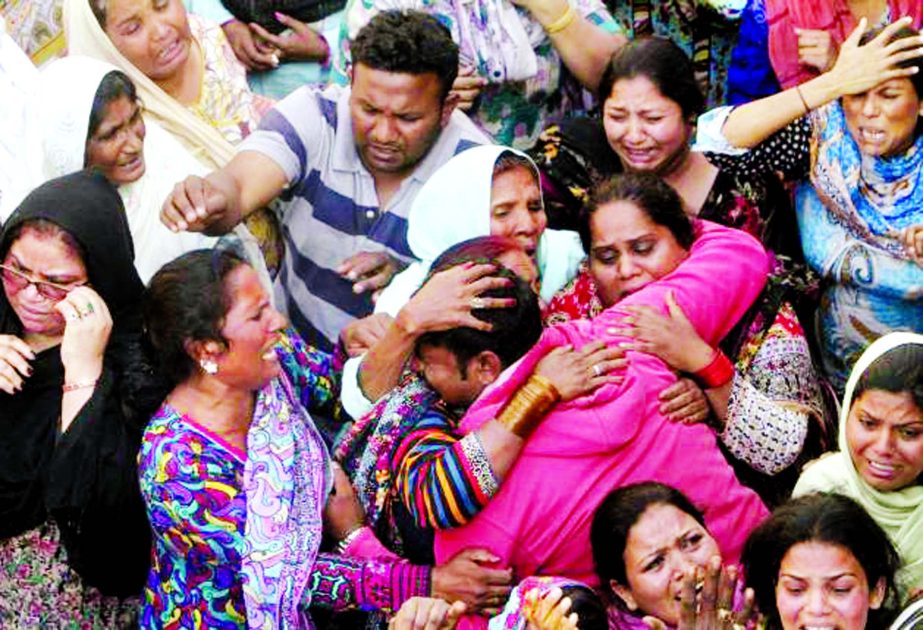 Family members mourn the death of a relative, who was killed in a blast outside a public park on Sunday, during funeral in Lahore, Pakistan, March 28.