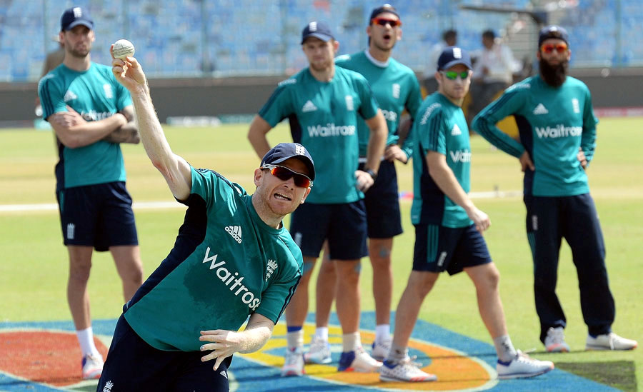 Eoin Morgan takes part in a fielding drill while watched by his team-mates in Delhi on Tuesday.