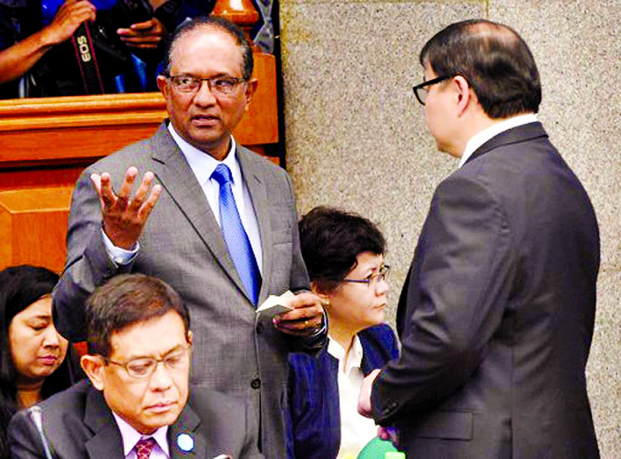 John Gomes (standing L), Bangladesh Ambassador to the Philippines, talks to Lorenzo Tan (standing R), President of Rizal Commercial Banking Corporation at a Senate hearing in Manila on Tuesday. Photo: Agency