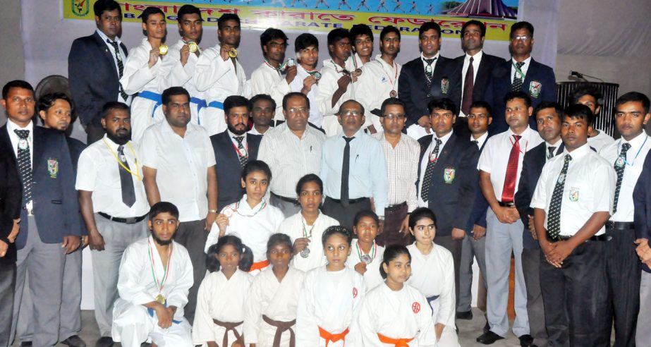 The winners of the Independence Day Karate Competition with the guests and the officials of Bangladesh Karate Federation pose for a photograph at the Gymnasium of the National Sports Council on Wednesday.