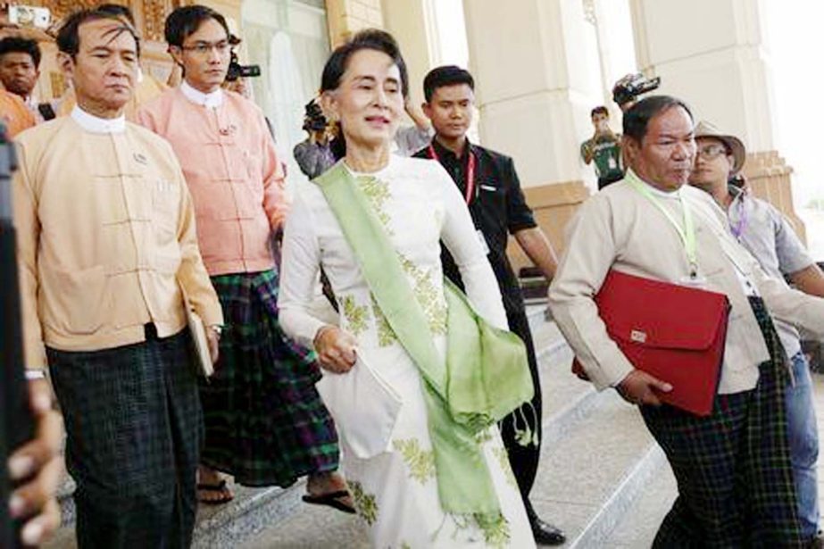 National League for Democracy (NLD) party leader Aung San Suu Kyi leaves the parliament building after a meeting with members of her party.