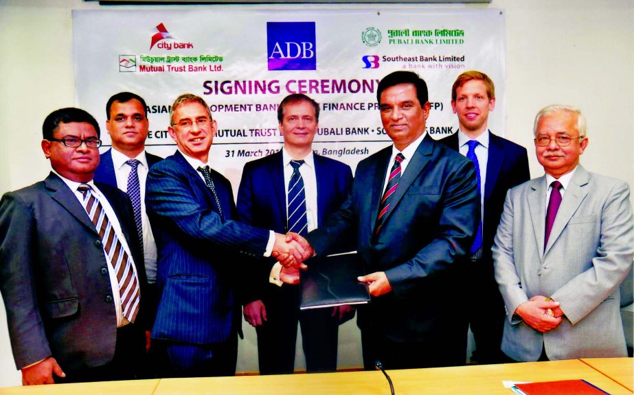 Md Abdul Halim Chowdhury, Managing Director of Pubali Bank and Steven Beck, Head of Trade Finance Unit sign a participating agreement at ADB Bangladesh Resident Mission on Thursday. Md Sayeed Ahmed FCA and Akhtar Hamid Khan- Deputy Managing Directors of P