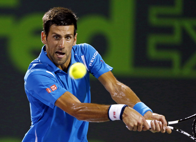 Novak Djokovic, of Serbia, returns the ball to Tomas Berdych, of the Czech Republic, at the Miami Open tennis tournament in Key Biscayne, Fla on Wednesday. Djokovic defeated Berdych 6-3, 6-3.