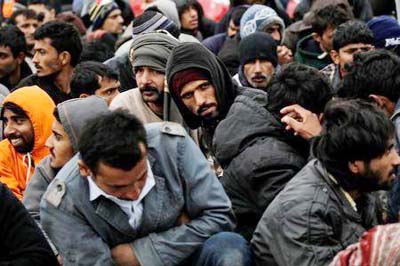 Refugees and migrants wait to be transferred to the Moria registration centre after arriving at the port of Mytilene on the Greek island of Lesbos.