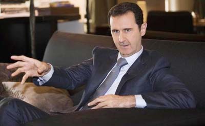 Syria's President Bashar al-Assad attends an interview with Russia's RIA news agency, in Damascus.