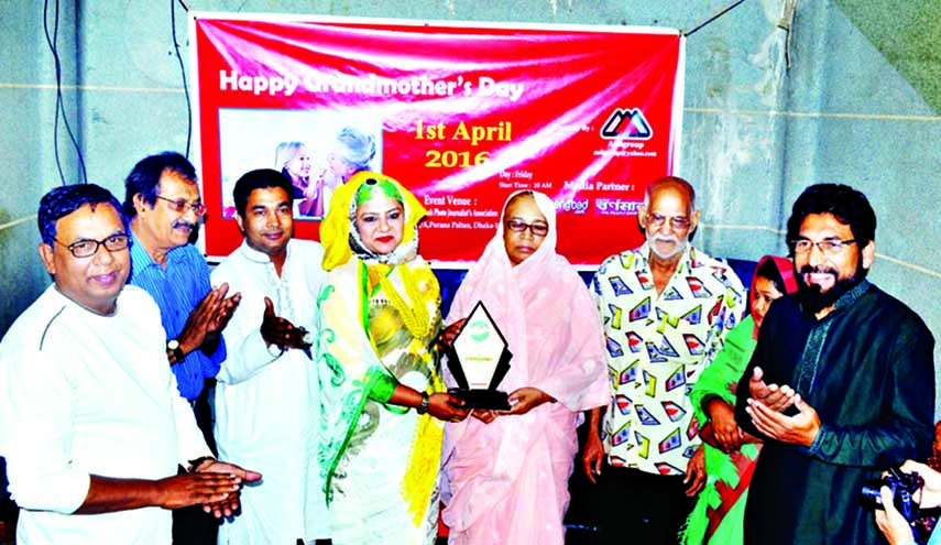 Participants at a ceremony organized in observance of World Grandmother Day in the auditorium of Photo Journalists Association in the city's Purana Palton on Friday.