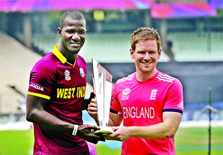West Indies' captain Darren Sammy (left) and England's captain Eoin Morgan pose with the winner's trophy a day ahead of their final match of the ICC World Twenty20 2016 cricket in Kolkata, India, on Saturday. Internet photo