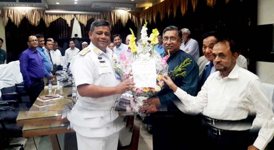 BICDA and SAA officials seen handing over bouquet to CPA Chairman Rear Admiral M Khaled Iqbal after signing MOU on container charges disputes at Bandar Bhaban on Sunday.