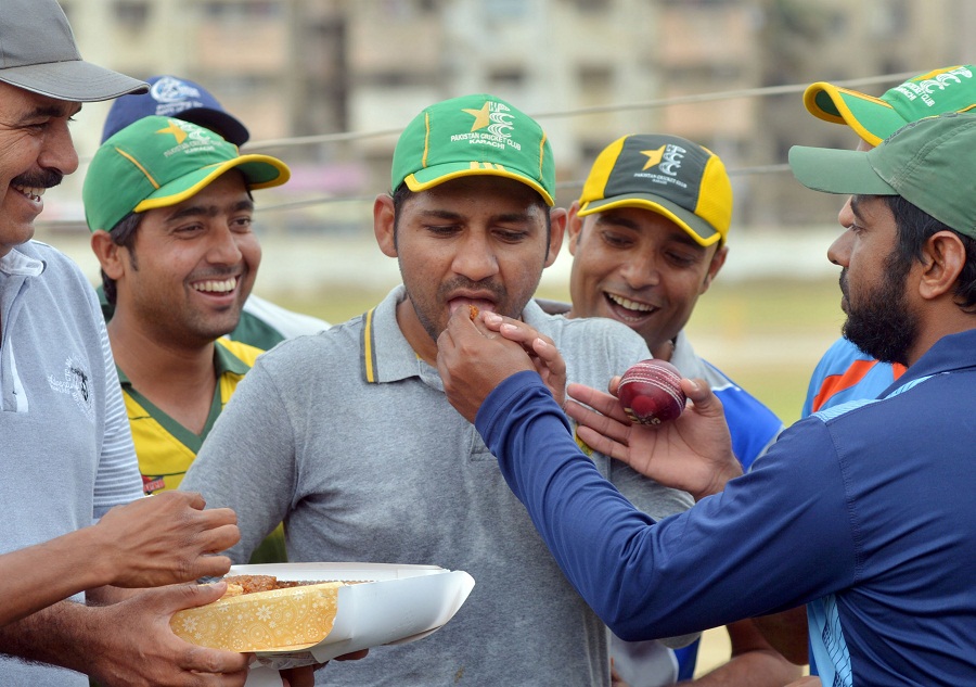 Sarfraz Ahmed is fed sweets after being named as Pakistan's T20I captain in Karachi on Tuesday.