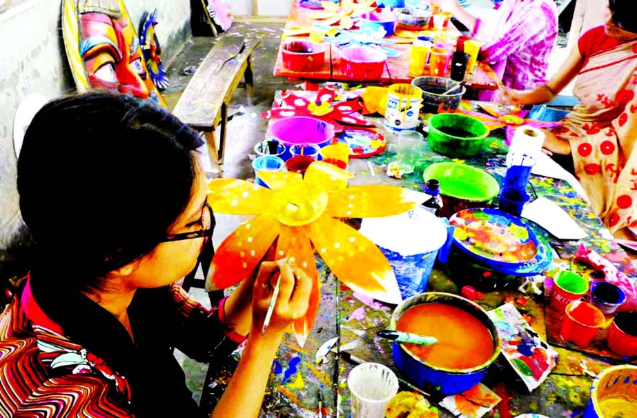 Brisk preparation goes on : Female students are busy in painting ahead of Pahela Baishakh celebration and Mongal rally on the occasion. This photo was taken from the Institution of Fine Arts on Saturday.