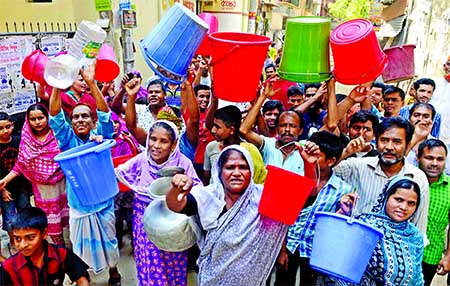 City dwellers staged a demonstration in the city with empty jars and pails near WASA water pump in Moghbazar area as water crisis prevailing for a few days in the city. This photo was taken on Sunday.