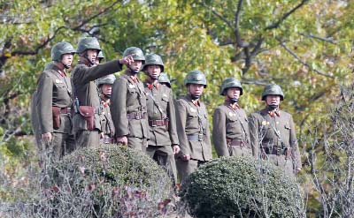 North Korean soldiers look at the South side at the truce village of Panmunjom in the Demilitarized Zone dividing the two Koreas.