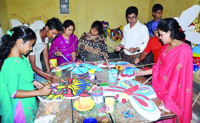 BOGRA: Students of Bogra Art College passing busy time for preparations of Pahela Baishakh on Sunday.