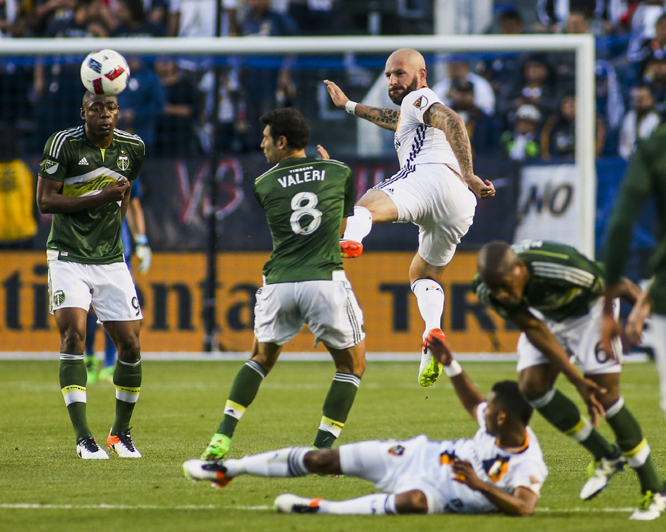 Los Angeles Galaxy defender Jelle Van Damme (center) kicks the ball against Portland Timbers during the first half of an MLS soccer game in Carson, Calif. on Sunday.