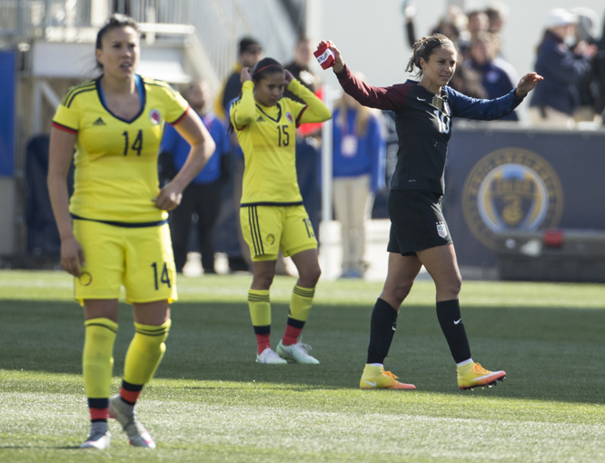 United States' Carli Lloyd (10) waves to the crowd as she exits the field with Colombia's Nataly Arias (14) and Tatiana Ariza (15) looking on during the second half of an international friendly soccer match in Chester on Sunday. The United States won 3