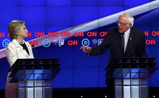 Democratic U.S. presidential candidate Hillary Clinton (L) listens as Senator Bernie Sanders speaks during a Democratic debate hosted by CNN and New York One at the Brooklyn Navy Yard in New York April 14, 2016. ReutersLucas Jackson