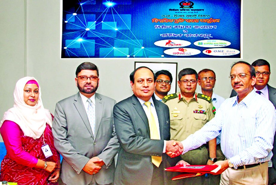 M Fakhrul Alam, Managing Director of ONE Bank Limited and Syed Mohammad Musa, Director (Operations), NID Registration Wings, Election Commission Secretariat sign an agreement at EC office in the city recently. Under this agreement the bank can verify its