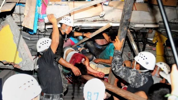 Two survivors are pulled from a collapsed building in the city of Manta