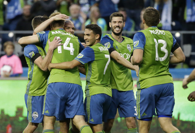 Seattle Sounders' Chad Marshall (14) is congratulated by teammates after he scored a goal against the Philadelphia Union during the first half of an MLS soccer match in Seattle on Saturday.