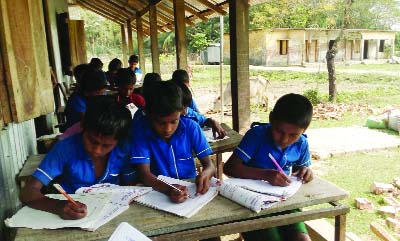 PATUAKHALI: A new school building is needed immediately as dilapidated condition of the old school building students of Uttar Chalitabunia Govt Primary School are attending their classes in a veranda of a tin-shed house. This picture was taken on Sund