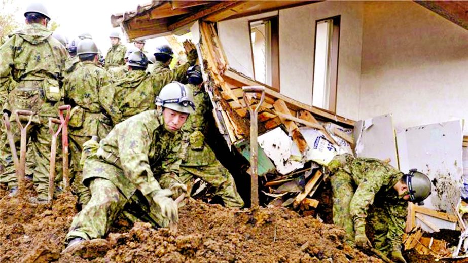 Japan's Self-Defence Force search for missing persons at the site of a landslide in Minamiaso, Kumamoto.