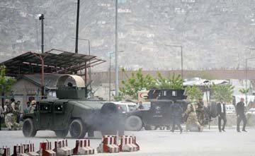 Afghan security personnel gather at the scene after a car bomb attack in Puli Mahmood Khan neighbourhood in Kabul.