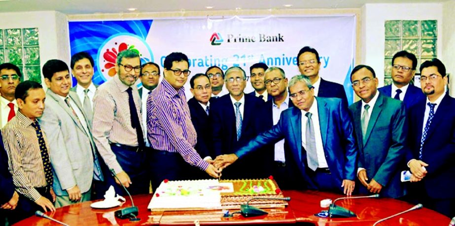 Managing Director of Prime Bank Ltd. Ahmed Kamal Khan Chowdhury cuts a cake to mark the bank's 21st Anniversary at Head Office recently. Deputy Managing Directors - Md. Tabarak Hossain Bhuiyan, Habibur Rahman, Md. Golam Rabbani, Md. Touhidul Alam Khan, S