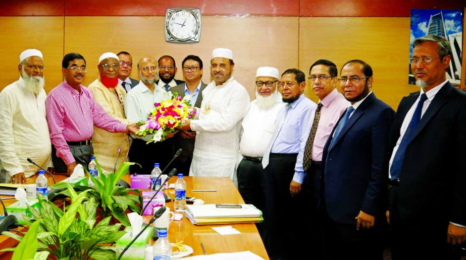 Badiur Rahman, Chairman of Al-Arafah Islami Bank Limited, presents a floral buquet to sponsor Director of Al-Arafah Islami Bank Limited and Chairman of AIBL Foundation Hafez Md Enayet Ullah for being elected as President of Moulovi Bazar Merchant Associa