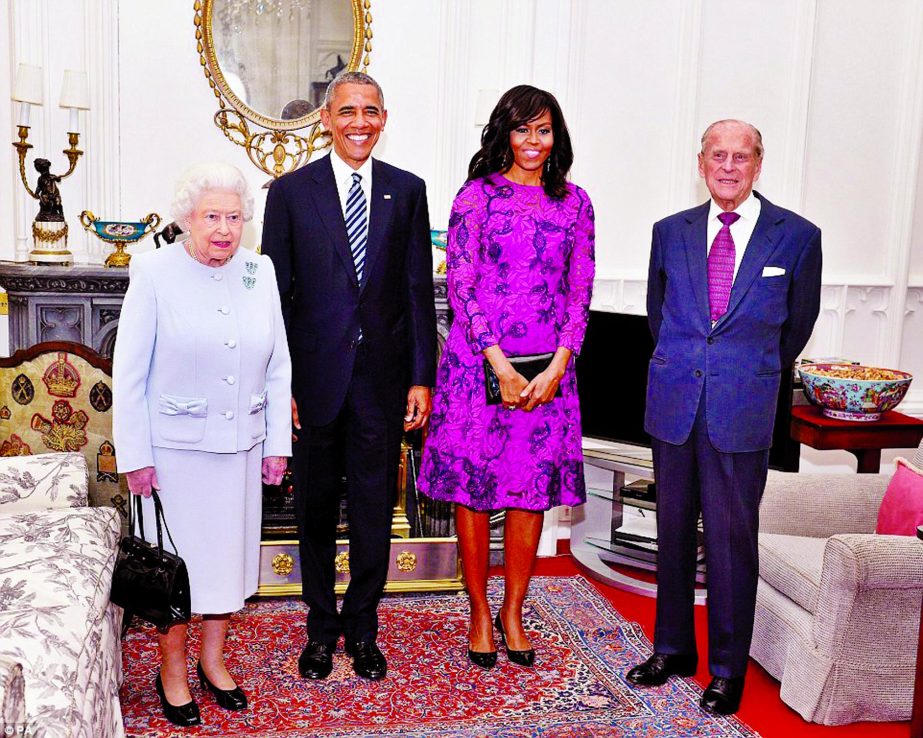 Barack and Michelle Obama smiling for the camera with the Queen Elizabeth and Prince Philip at Windsor Castle on Friday. (News on page-14)