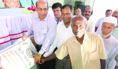 KISHOREGANJ: Azimuddin Biswas, DC, Kishoreganj distributing fertilizer among farmers at Upazila Hall Room on Sunday.