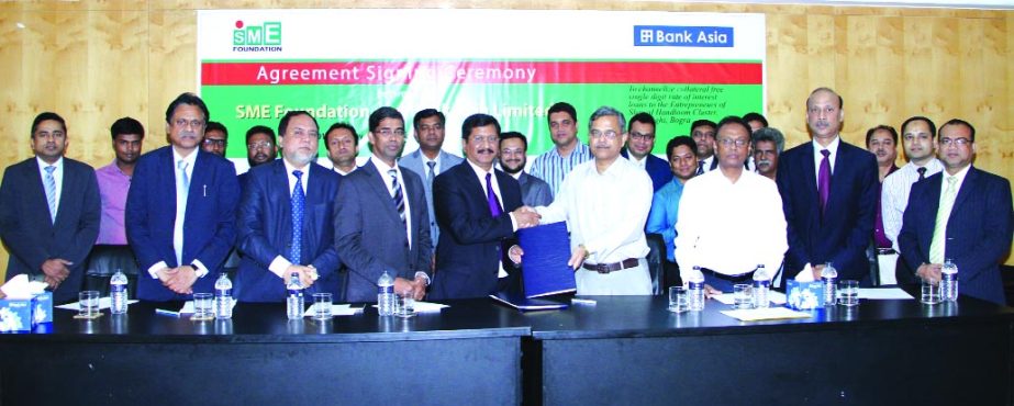 Md Mehmood Husain, Managing Director of Bank Asia and Md Safiqul Islam, Managing Director of SME Foundation, exchanging agreement recently in the capital city Dhaka on financing the cluster of handloom and specialized cloth production in Adamdighi, Bogra.