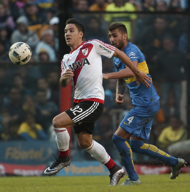 Sebastian Driussi of River Plate (left) fights for the ball with Gino Peruzzi of Boca Juniors during a Argentina league soccer match in Buenos Aires, Argentina on Sunday.