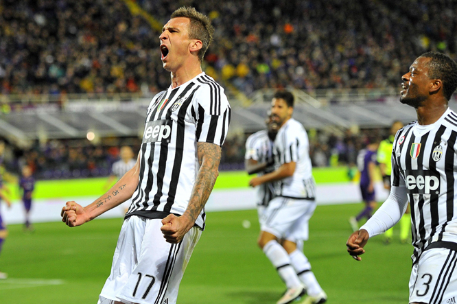 Juventus's Mario Mandukic (left) celebrates after he scored during a Serie A soccer match at the Artemio Franchi stadium in Florence, Italy on Sunday.