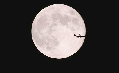 An aeroplane is silhouetted against a full moon in the sky on a Mid-Autumn Festival night in Xuyi, Jiangsu province.