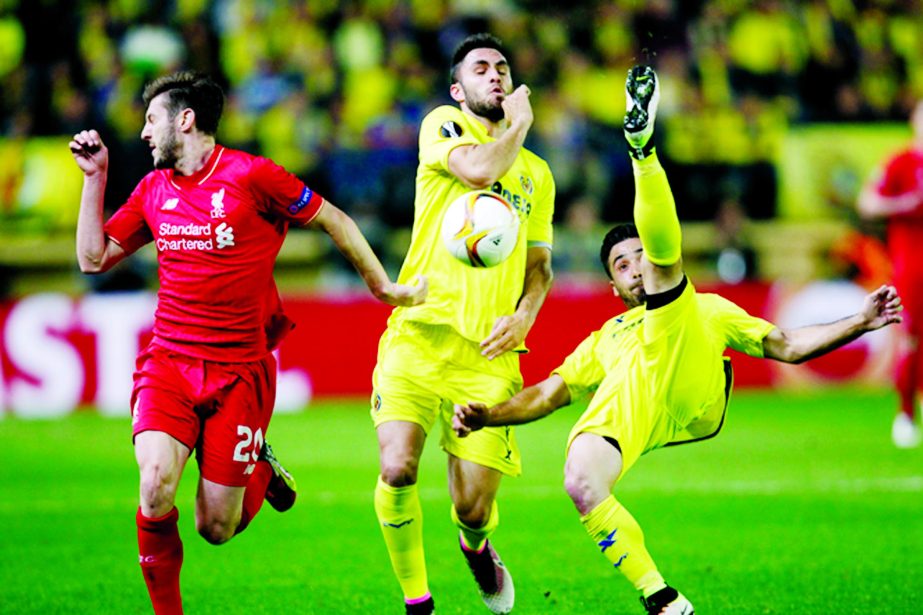 Villarealâ€™s Jaume Costa (right) tries to clear the ball away from Villarealâ€™s Victor Ruiz and Liverpoolâ€™s Adam Lallana (left) during their Europa League semifinal first leg soccer match between Villarreal and Liverpool FC at the Madri