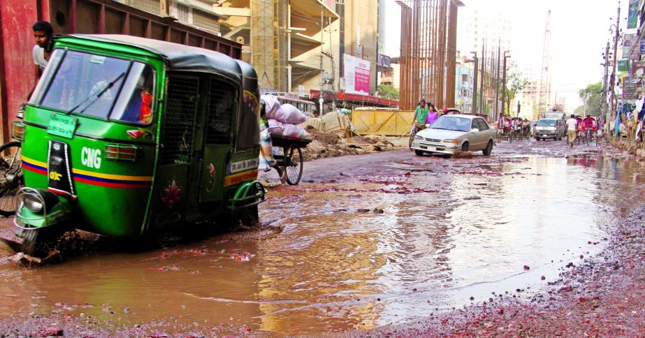 Local residents and vehicles movement have been facing trouble in city's Malibagh area as ditches developed on the road adjacent to under-constructed flyover where sewage and muddy waters are stagnant there. This photo was taken on Friday.