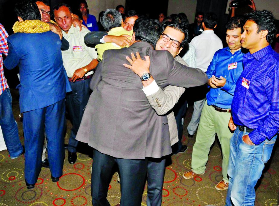 Kazi Nabil Ahmad, MP, embracing with his colleague after electing the Vice-President of BFF at the Radisson Blu Water Garden Hotel in the city on Saturday.