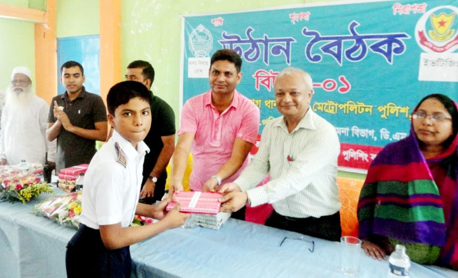 Deputy Police Commissioner of Ramna Zone Md Ashraful Islam handing over books to the students of Segun Bagicha High School at an awareness buildup programme against Eve-teasing and Child Marriage. Headmaster of the Segun Bagicha High School AKM Obaidullah