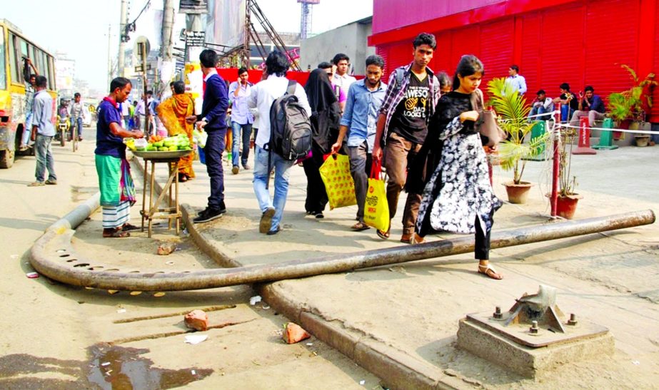 A lampost lying collapsed on a footpath near Bashundhara gate for long, but the authority did not remove it yet causing daily sufferings to commuters. This photo was taken on Saturday.