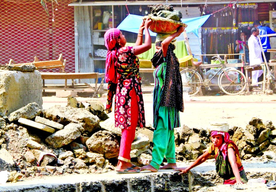 Women labourers are active in road development work in the city.