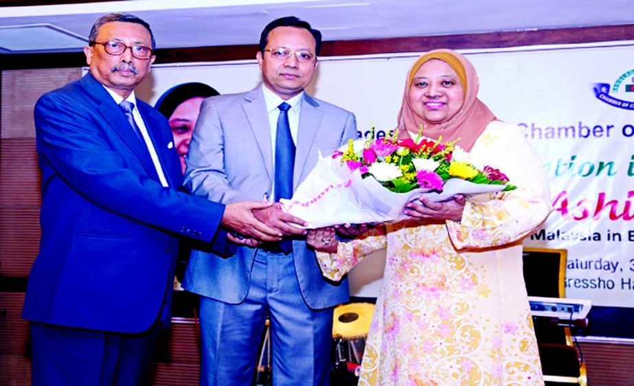 BMCCI President Ar. Md. Alamgir Jalil presents flower bouquet to the new High Commissioner of Malaysia in Bangladesh Nur Ashikin Mohd Taib at a reception in a city hotel.