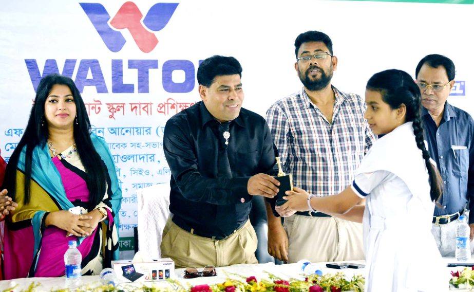 Senior Additional Director of Walton Group FM Iqbal Bin Anwar Dawn handing over a prize to a winner of the Walton Talent Hunt School Chess Training Workshop held at the Tejgaon Government Girls High School on Tuesday.