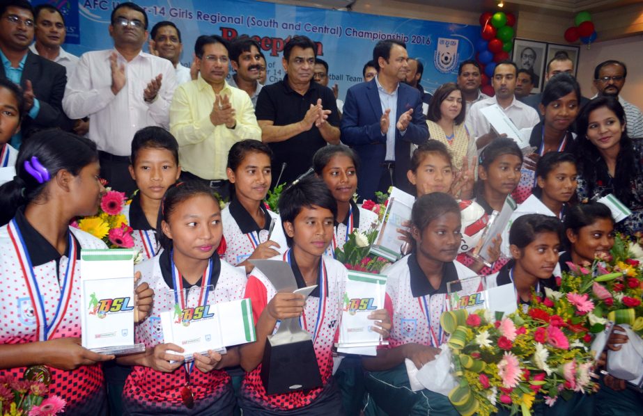 Members of Bangladesh Under-14 Girls' Football team, the champions of the recently concluded AFC Under-14 Girls' Regional Championship with the officials of Bangladesh Football Federation (BFF) pose for a photo session at the BFF House on Tuesday. BFF a