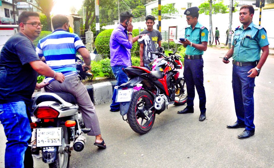 Members of law enforcing agencies examining documents of motor cyclists. This photo was taken from city's Tikatuli crossing on Tuesday.