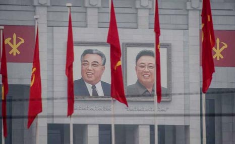 Portraits of late North Korean leaders Kim Il-Sung (L) and Kim Jong-Il (R) on the 'April 25 Palace', the venue of the 7th Workers Party Congress in Pyongyang on Friday.