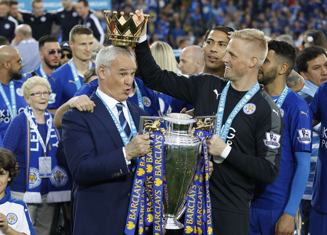 Leicesterâ€™s team manager Claudio Ranieri gets a crown by Leicesterâ€™s goalkeeper Kasper Schmeichel as they lift the trophy as Leicester City celebrate becoming the English Premier League soccer champions at King Power stadium in Leicester, E