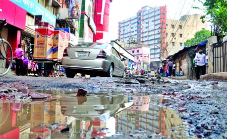 Precarious condition of a busy street in front of city's Rajdhani Market in Wari area. This photo was taken on Tuesday.